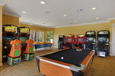 a games room with a pool table and arcade machines at New Gorgeous Townhome, Epic Universe, Vista Cay - 4008 in Orlando
