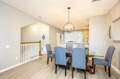 a dining room with a table and blue chairs at New Gorgeous Townhome, Epic Universe, Vista Cay - 4008 in Orlando