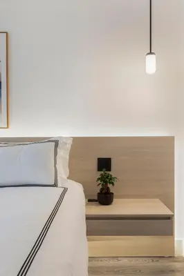 a bedroom with a bed and a table with a plant at The Vietta Hotel in Kissimmee