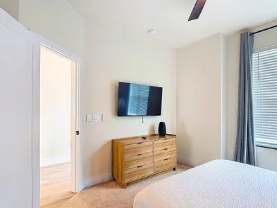 a bedroom with a bed and a tv on a wall at Spacious 3BR with Clubhouses and Splash Fun in Orlando