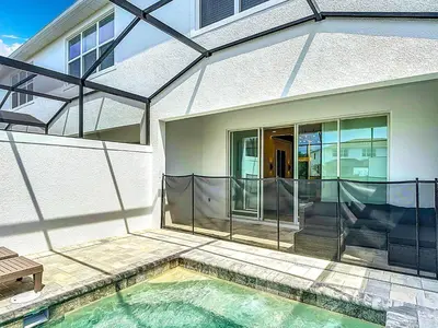 a house with a swimming pool in front of a house at Spacious 3BR with Clubhouses and Splash Fun in Orlando