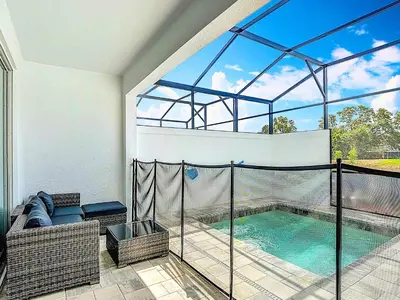 a swimming pool inside of a house with a balcony at Spacious 3BR with Clubhouses and Splash Fun in Orlando