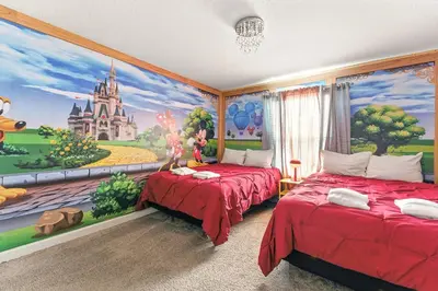 a bedroom with two beds and a castle mural at Relax Near Disney 4BR Home with Pool in Kissimmee