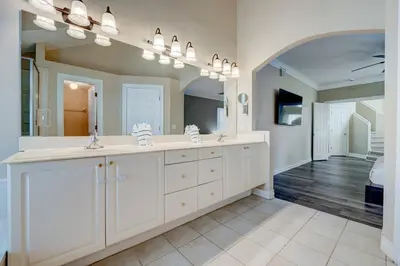 a bathroom with two sinks and a large mirror at Bay Pointe Pool Home Near Parks in Kissimmee