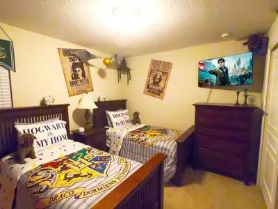 a bedroom with two beds and a flat screen tv at Windsor Hills Resort - Disney Dream Palace in Orlando