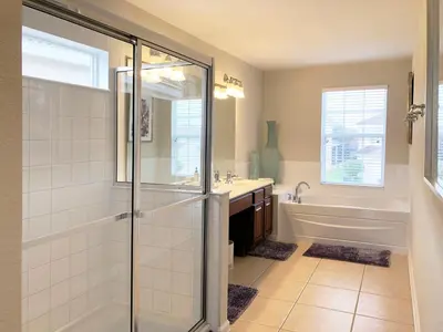 a bathroom with a shower and a sink and a tub at Windsor Hills Resort - Disney Dream Palace in Orlando
