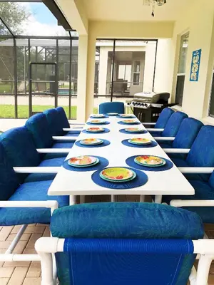 a long table with blue chairs and plates on it at Windsor Hills Resort - Disney Dream Palace in Orlando