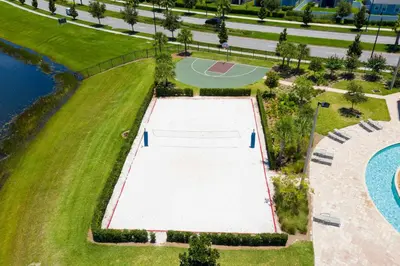 an overhead view of a tennis court next to a pool at 4BR Townhome with Pool at Storey Lake in Kissimmee