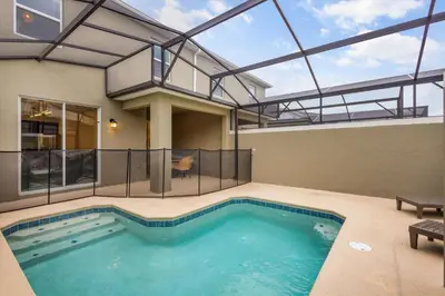 a swimming pool in a house with a glass roof at Stylish Family Retreat with Themed Bedrooms in Kissimmee