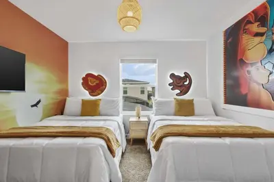 two beds in a room with white walls at Stylish Family Retreat with Themed Bedrooms in Kissimmee