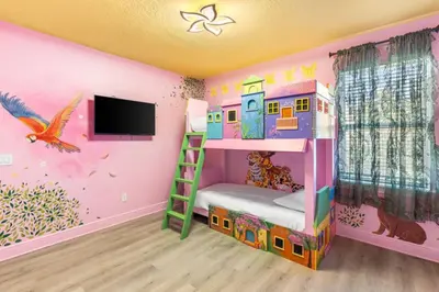 a childs bedroom with a bunk bed and a tv at Fantastic 6BR Themed Encore Home in Orlando