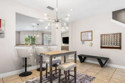 a dining room and kitchen with a table and chairs at Fantastic 6BR Themed Encore Home in Orlando