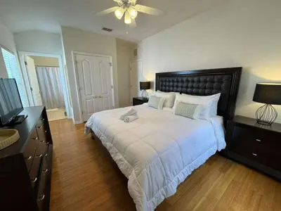 a bedroom with a large white bed with a ceiling at 2335 Amazing 5BD Family Townhome Close to Disney in Kissimmee