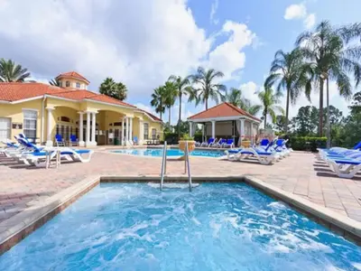 a swimming pool with chairs and a house at The Minions Mansion 6br Resort Pool Home By Disney in Kissimmee