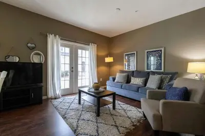 a living room with a couch and a tv at 4BR Family Townhouse Steps to Disney in Kissimmee