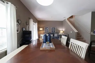a dining room with a table and a couch at 4BR Family Townhouse Steps to Disney in Kissimmee