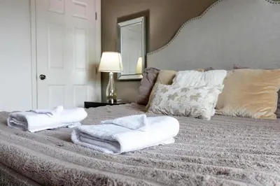a bedroom with a bed with towels on it at 4BR Family Townhouse Steps to Disney in Kissimmee