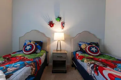 two beds sitting next to each other in a room at 4BR Family Townhouse Steps to Disney in Kissimmee
