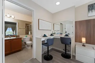 a bathroom with a vanity and a toilet and a sink at King Queen Spacious Studio Near Universal in Orlando