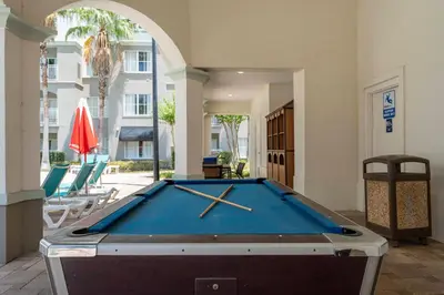 a pool table in the middle of a room at Combined units 2 Kitchens Sleeps 6 in Orlando
