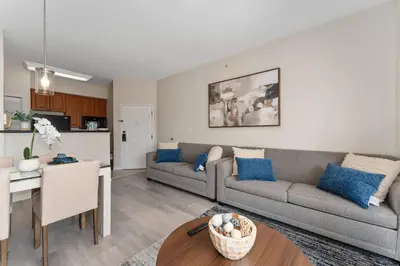 a living room with a couch and a table at Combined units 2 Kitchens Sleeps 6 in Orlando