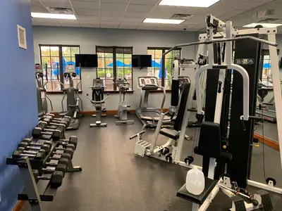 a gym with several rows of tread machines at Relaxing Villa very close to Disney and Universal in Kissimmee