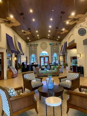 a lobby with couches and tables in a building at Relaxing Villa very close to Disney and Universal in Kissimmee