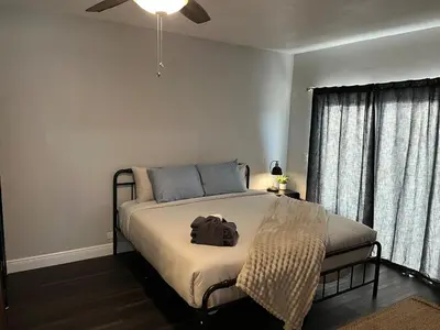 a bedroom with a bed with a backpack on it at Beautiful Guest Suite with Private Driveway and Entrance in Orlando
