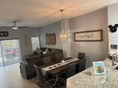a living room with a table and a couch at Holiday Haven at Terra Verde Resort in Kissimmee