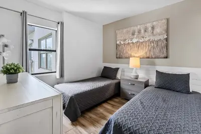 a bedroom with two beds and a window at NEW Amazing 2 Bedrooms Nex to Universal in Orlando