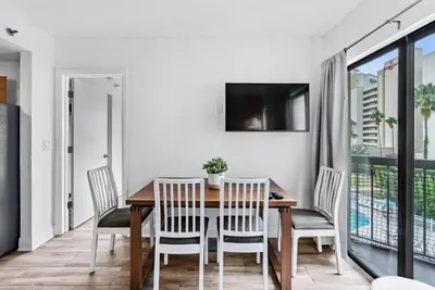 a dining room with a wooden table and chairs at NEW Amazing 2 Bedrooms Nex to Universal in Orlando