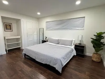 a bedroom with a bed and a white wall at Family Fun 3-bedroom house with gym, games, toys, outdoor hangout and coffee in Orlando