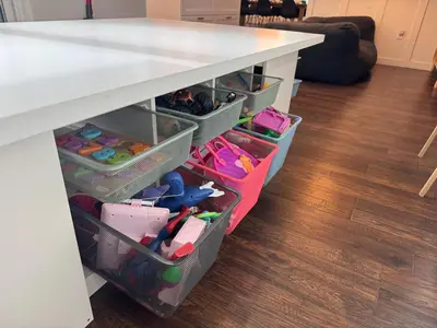 a white table with drawers under a counter with toys at Family Fun 3-bedroom house with gym, games, toys, outdoor hangout and coffee in Orlando