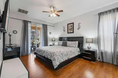 a bedroom with a bed and a ceiling fan at 7 Bed Family Villa for All in Kissimmee