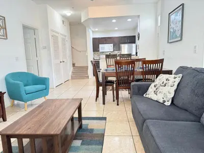 a living room with a couch and a table at 4 Bedroom 3 Bathroom Villas At SevenDwarfs 4-108 in Kissimmee