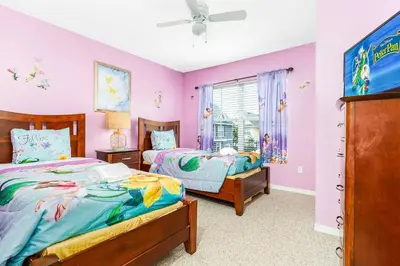 two beds in a room with pink walls at 4 Bedroom 3 Bathroom Villas At SevenDwarfs 4-108 in Kissimmee