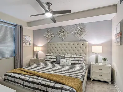 a bedroom with a large bed and a ceiling fan at Storey Lake Beautiful 2-BR Condo, Resort Amenities in Kissimmee