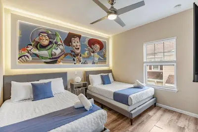 a bedroom with two beds and a painting on the wall at Thematic 4 bdr near Disney-22101 in Kissimmee