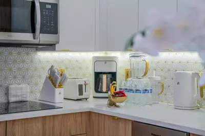 a kitchen counter with a microwave and appliances on it at Orlando 2BR Apt Full Kitchen Near Parks in Orlando