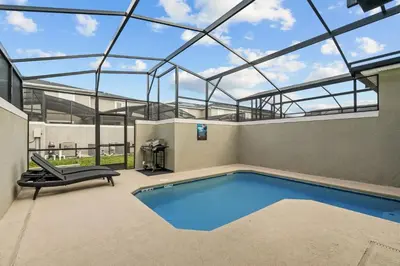 an indoor swimming pool with a glass roof at Casa moderna com piscina privativa perto da Disney in Kissimmee