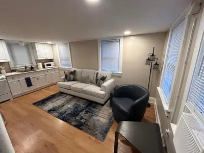 a living room with a couch and a chair at Cute and Cozy Apt Near Historic Downtown Sanford in Sanford