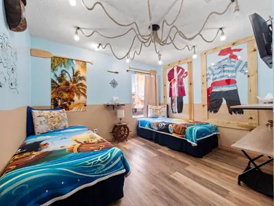 a bedroom with two beds and a chandelier at bsv_villa8513 in Kissimmee
