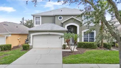 a house with a driveway and a garage at bsv_villa8513 in Kissimmee