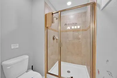 a shower with a glass door in a bathroom at Disney Themed Home l Private Pool l Lazy River in Kissimmee
