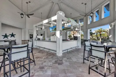 a kitchen and dining room with chairs and tables at Disney Themed Home l Private Pool l Lazy River in Kissimmee