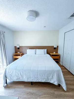 a bedroom with a large white bed with two night stands at Kissimmee Vacation Beautiful Home in Kissimmee