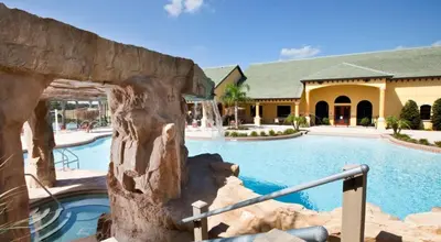 a resort with a large swimming pool and a building at Adorable Townhouse Completely Remodeled,3002Pp in Kissimmee