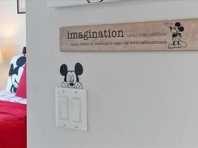 a sign on a wall with a mickey mouse on a switch at Adorable Townhouse Completely Remodeled,3002Pp in Kissimmee
