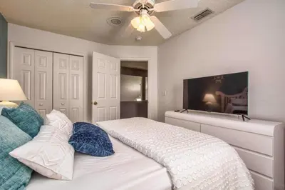 a bedroom with a bed and a ceiling fan at Waterfront Privacy On Disneys Doorstep, Spa!2101O in Orlando
