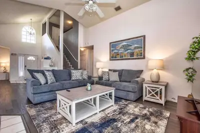 a living room with a couch and a table at Waterfront Privacy On Disneys Doorstep, Spa!2101O in Orlando